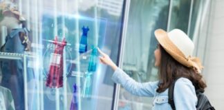 How Artificial Intelligence is Changing the Fashion Industry girl using virtual digital display to pick her fashion clothing