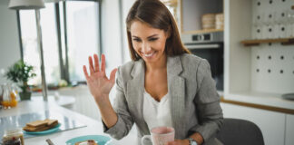 The Great Resignation and Keeping Knowledge in Your Company woman employee waving goodbye on laptop resignation