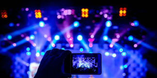 Restrictions May Be Ending but the Virtual Events Era is Far from Over phone filming a physical event versus virtual events