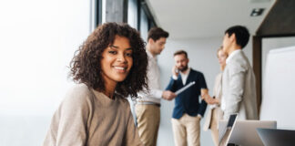 Lessons that Inspired Our Company to Emphasize Humans in Technology smiling girl on laptop in employee office