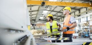 How To Increase Production at a Metal Manufacturing Plant two men working at a metal manufacturing plant