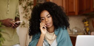 Decentralized Finance – The Opportunity Towards Financial Autonomy Woman using her laptop and taking on the smartphone, working to gain financial autonomy