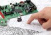 Benefits of Designing Your Own Printed Circuit Board man reviewing schematics of printed circuit board