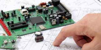 Benefits of Designing Your Own Printed Circuit Board man reviewing schematics of printed circuit board