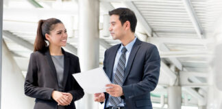 Five Factors Influencing Large IT Companies Buying Small IT Firms businessman and business woman discussing company purchase