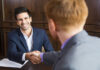 Four Questions to Avoid Rooking Mistakes in Selling a Business businessmen shaking hands and selling a business