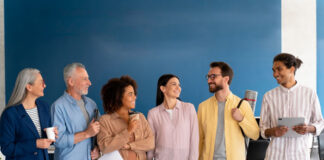 8 Tips to Run More Effective Daily Standup Meetings company employees having a fun stand up meeting