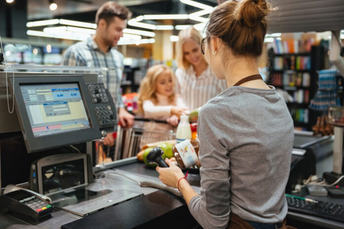 girl working cash register at a brick-and-mortar store