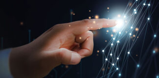 Why Factories Digitize and How To Do It Right human hand touching and illuminating digital strategy touchpoints