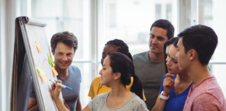 Invest In Yourself, Others: Tips for Developing Tech Leadership Skills woman tech leaders demonstrating to her peers