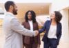 How to Win More M&A Deals with Half of Your Resources businessman shaking business woman's hand during merger deal