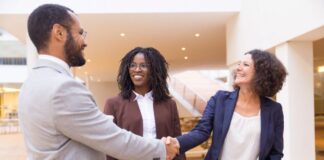 How to Win More M&A Deals with Half of Your Resources businessman shaking business woman's hand during merger deal