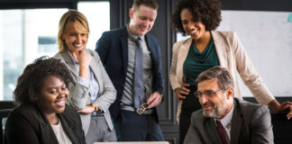 Managed Services Providers: 2022 M&A Trend for Sellers- Part 3 business people reviewing a presentation on M&A trends for sellers