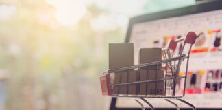 Three Important Considerations for New Online Marketplaces picture of a miniature shopping cart sitting on a laptop representing the online marketplace
