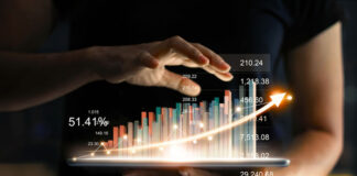 How Private Markets Help Business Owners Fund Their Growth Ambitions business owner holding a tablet displaying a digital growth chart for private markets