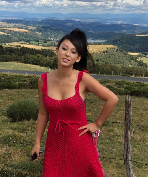 Tesha Jie in a red dress out in the French countryside