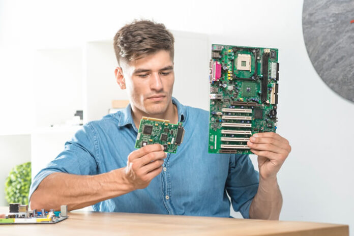 young man choosing the right computer hardware for his business