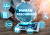 Top Trends for HR in 2023 and Beyond woman using a tablet to select the top trends for HR
