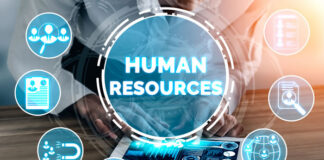 Top Trends for HR in 2023 and Beyond woman using a tablet to select the top trends for HR