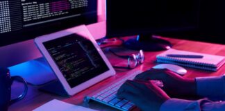 How To Increase Business Efficiency with Microsoft PowerApps man using Microsoft PowerApps on this computer desk