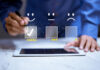 Consumer Satisfaction: The Key to Driving Sales in 2023 man on tablet providing a customer satisfaction review