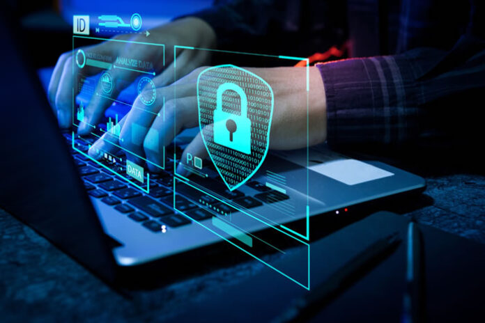 cybersecurity expert on laptop keeping enterprises cybersecure