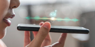 A Look Inside VoiceTech: Uncovering the Power of Tonal Intelligence woman speaking into smart phone displaying the power of tonal intelligence