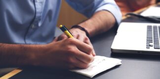 4 Phases of Every Successful Disaster Recovery Plan man writing out 4 phases of successful disaster recover plan