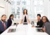 5 Sales Mistakes to Avoid in Your Consulting Business Woman Standing on the Center Table With Four People on the Side in your consulting business