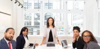 5 Sales Mistakes to Avoid in Your Consulting Business Woman Standing on the Center Table With Four People on the Side in your consulting business