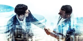 Challenges and Opportunities in Cross-Border IT M&A two businessmen handshaking in a cross-border IT M&A deal