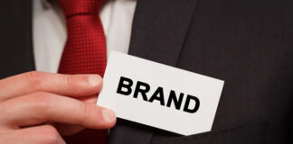 The Importance of Building Your Personal Brand businessman pulling out card from suit pocket while building your personal brand