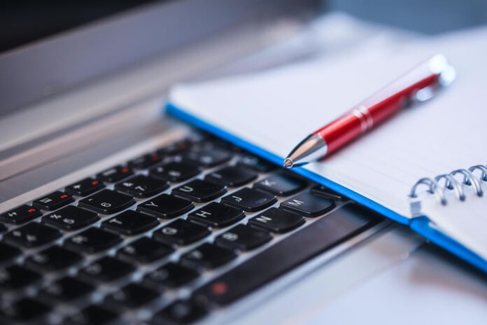a pen, notepad, and keyboard - the key to technical writing