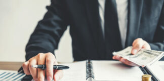 Navigating the Complexities of Startup Compensation in Today’s Market entrepreneur calculating money for startup compensation