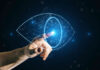 Consumer Demand Fuels the Rise of Visual Search Technology man pressing a digital eye representing visual search technology