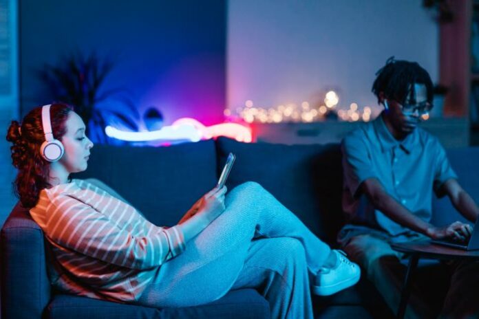 two people on a couch relaxing and playing the best games