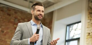 Volunteer Your Time and Expertise to Further Build Your Brand businessman with microphone speaking about how to volunteer your time and expertise