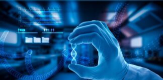 Cancer Vaccines: Where are We Now and Where are We Going? researcher holding up a DNA representation of cancer vaccines