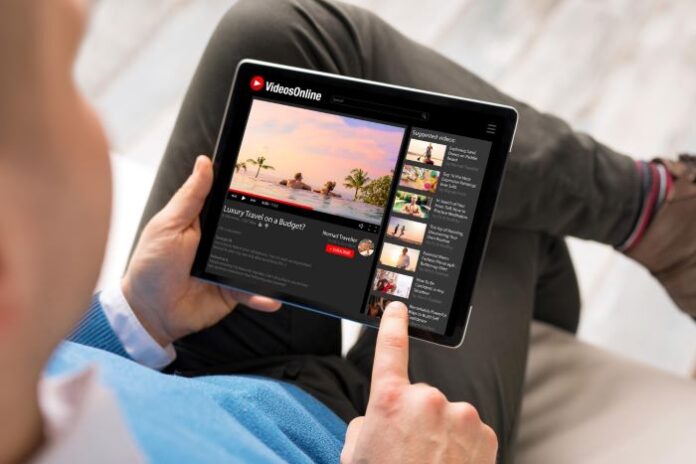 man streaming video on tablet using Optimum Stream Device