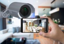Tips for Setting up and Maintaining Wireless Alarm Systems woman setting up and maintaining wireless alarm systems with her smart phone