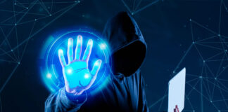Heightened Cyber Threats Expected in Winter 2024 hacker with laptop holding up hand to launch cyber threats