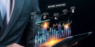 Looking Ahead to 2024 – How Can We Prepare Our Finances? man using a tablet with a holographic finance dashboard and how we prepare our finances