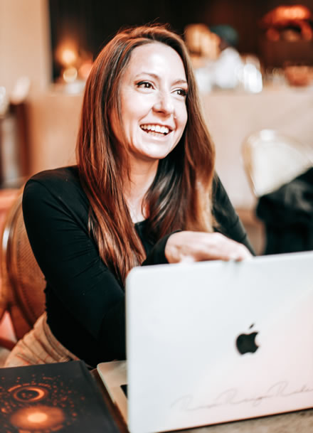 Rebecca Korn smiling and closing laptop