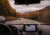 5 Essential Features To Look For In A GPS Vehicle Tracking System Car riding on highway through autumn forest