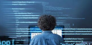 Python Developer vs. Software Engineer young software engineer and Python developer writing code at his desk