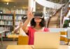 Immersive Learning in Fostering Teamwork and Collaboration Skills woman using VR goggles in the library for immersive learning