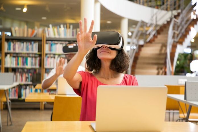 woman using VR goggles in the library for immersive learning