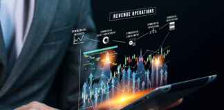 What Is FinOps? businessman using a tablet and looking at a FinOps dashboard