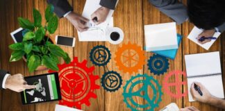 Adapting Asset Lifecycle Management to Remote Work Challenges people around a conference table working on asset lifecycle management