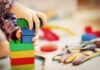 Beginning the Journey of Starting a Daycare Business Outside Your Home child building with Lego blocks in a daycare business